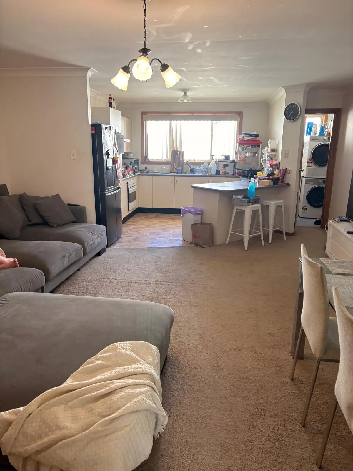 Tired long-term rental — open-plan living, kitchen and dining as it stands today